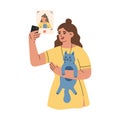 Young woman with cat in here hands taking selfie. Girl using phone camera for making photo
