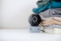 Webcam hidden in a stack of clothes for covert surveillance of the house. Royalty Free Stock Photo