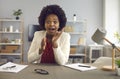 Happy businesswoman sitting at desk and looking at camera with surprised face expression Royalty Free Stock Photo