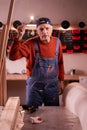 Webcam view of angry mature carpenter showing fist, protesting about business problems from workshop. Handmade, small business Royalty Free Stock Photo