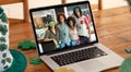 Webcam view of group of friends at a bar on video call on laptop on wooden table