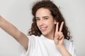 Webcam view 20s woman showing rock and roll hand gesture Royalty Free Stock Photo