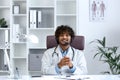 Webcam view, young doctor with headset phone using laptop for video call, doctor cheerfully and friendly consulting Royalty Free Stock Photo