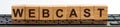 Webcast word made with building blocks. A row of wooden cubes with a word written in black font is located on a keyboard