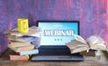 Webinar concept, online education, training program online. Workspace,books, laptop Royalty Free Stock Photo