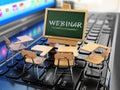 Webinar concept. Schooldesk and chalkboard on the laptop keyboard.