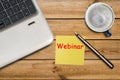 Webinar Concept. Webinar written on sticky note, laptop and cup of coffee on table, top view Royalty Free Stock Photo