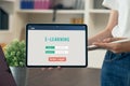 Webinar Online Courses concept, woman holding tablet with show screen e-learning login to classroom. Royalty Free Stock Photo