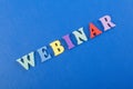 WEBINAR word on blue background composed from colorful abc alphabet block wooden letters, copy space for ad text