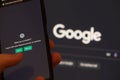 Webpages of chat bot ChatGPT, OpenAI chatbot, and Google logo are seen on smartphones and background