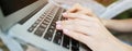 Website header and banner of closeup female hands typing on laptop keyboard. Royalty Free Stock Photo