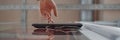 Header Image of Hand of Woman Using Touch Screen Entering Code Indoors