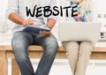 Website text against midsection of couple with laptop and digital tablet Royalty Free Stock Photo