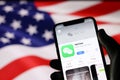 WeChat application on mobile phone screen on USA flag background