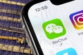 Wechat messenger application icon on Apple iPhone X smartphone screen close-up. Wechat messenger app icon. Social media network