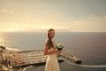 Wedding abroad. Pretty happy bride in white dress with wedding bouquet Royalty Free Stock Photo