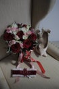 A bride`s bouquet of red and pink roses, women`s shoes, a garter of the bride Royalty Free Stock Photo