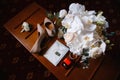 Wedding accessories: bridal bouquet, two buttonholes, women`s shoes, wedding rings in a box, women`s bracelet, envelope with a Royalty Free Stock Photo