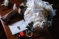 Wedding accessories: bridal bouquet, two buttonholes, women`s shoes, wedding rings in a box, women`s bracelet, envelope with a Royalty Free Stock Photo