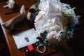 Wedding accessories: bridal bouquet, two buttonholes, women`s shoes, wedding rings in a box, women`s bracelet, envelope with a Royalty Free Stock Photo