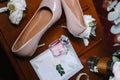 Bridal bouquet, two buttonholes, women`s shoes, wedding rings in a box, women`s bracelet, envelope with a wed Royalty Free Stock Photo