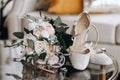 Wedding accessories of the bride in the form of a bouquet of roses, high-heeled shoes, wedding rings and perfume Royalty Free Stock Photo