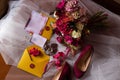 A brideÃ¢â¬â¢s bouquet of roses, peonies and hydrangeas, wedding rings on a stone, a ring and earrings with Royalty Free Stock Photo