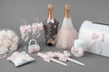 Wedding accessories: decorated bottles of champagne, wine glasses, candles, box for money, wedding lock, flower bouquet. Royalty Free Stock Photo