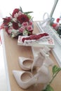 A bride`s bouquet of red and pink roses, women`s shoes, a garter of the bride Royalty Free Stock Photo