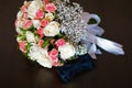 Wedding accessories of the groom, dark blue butterfly with a flower bouquet