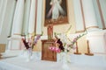 Wedding accessories and interior in Saint Trinity Orthodox Convent including two candlesticks with many candles, flowers, icons Royalty Free Stock Photo