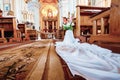 Wedding accessories and interior in Saint Trinity Orthodox Convent including two candlesticks with many candles, flowers, icons Royalty Free Stock Photo