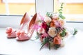 Wedding accessories for the morning of the bride in pink . Wedding bouquet and shoes of the bride. Royalty Free Stock Photo