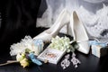 Wedding rings in a decorative box with flowers, earrings, women`s shoes, a garter of the bride, a small gift