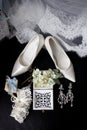 Wedding rings in a decorative box with flowers, earrings, women`s shoes, a garter of the bride, a small gift