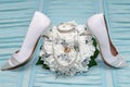 Wedding accessories. Two wedding rings in a bridal bouquet, earrings, bracelet, necklace and bridal shoes.
