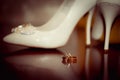 Wedding accessories. Wedding rings and bridesmaid shoes Royalty Free Stock Photo