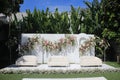 wedding altar and row of brown and white chairs shot at low angle prepared on the beautiful park or garden