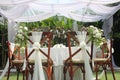 wedding altar and row of brown chairs shot at low angle prepared on the beautiful park or garden Royalty Free Stock Photo