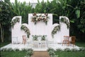 wedding altar with brown and white chairs shot at eye level angle prepared on the beautiful park or garden Royalty Free Stock Photo