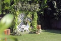 wedding altar with single white chairs shot at low angle prepared on the beautiful park or garden Royalty Free Stock Photo