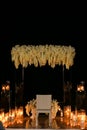 Wedding amazing altar with many burning candes at night.