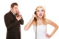 Wedding. Angry bride and groom talking on phone Royalty Free Stock Photo