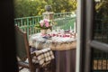 Romantic decor of the festive table in the restaurant with candles, flowers, rose petals