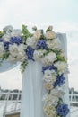 Wedding arch for the ceremony on the roof of the building, fragment, close up. Symbol of eternal love between man and woman.