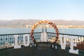 Wedding arch decorated with big letters love and lamps, ceremony place for the bride and groom, decor, flowers pink and