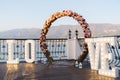 Wedding arch decorated with big letters love and lamps, ceremony place for the bride and groom, decor, flowers pink and