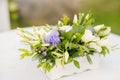 The wedding arch is decorated with blue flowers and white light silk. Summer ceremony. Bridal bouquet Royalty Free Stock Photo