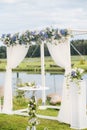 The wedding arch is decorated with blue flowers and white light silk. Summer Wedding Ceremony Royalty Free Stock Photo
