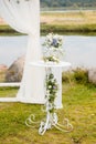 The wedding arch is decorated with blue flowers and white light silk. Summer Wedding Ceremony Royalty Free Stock Photo